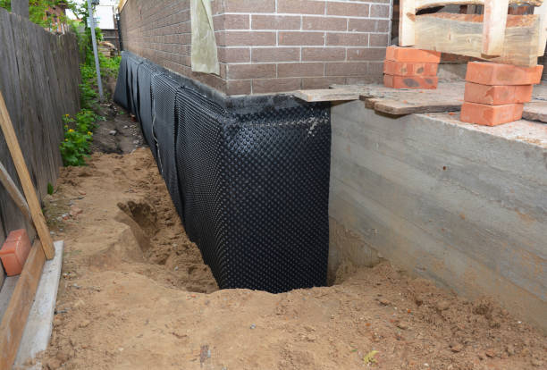 SJ Waterproofing Pros technician performing targeted Interior Drainage System assessment in Holland, MI